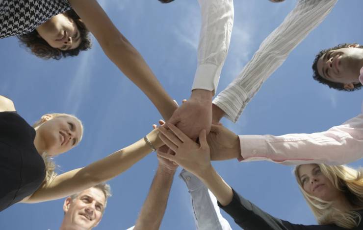 team members in a group huddle