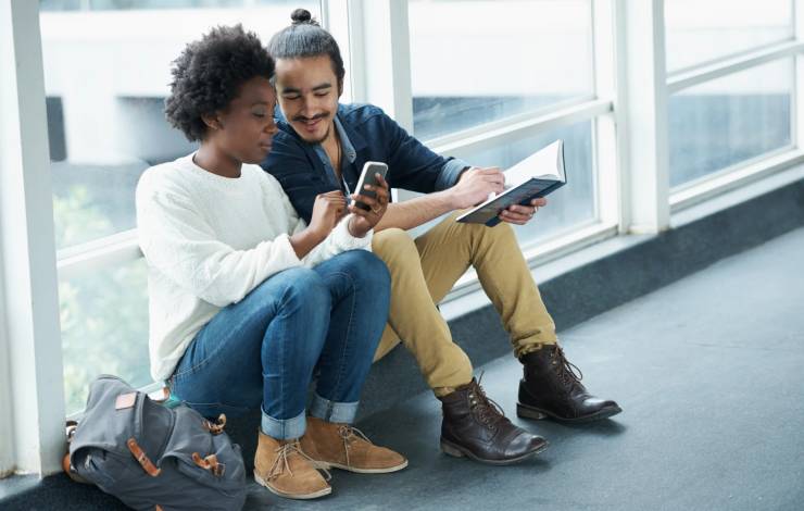 Two people looking at mobile phone