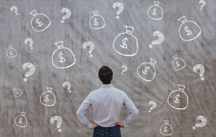 man staring at wall with money drawn on it