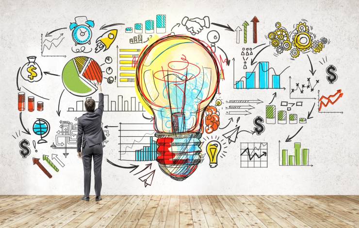 man with drawings on wall implying market research