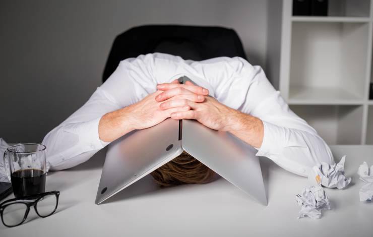 Man frustrated with computer over head