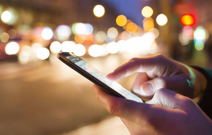 person on cell phone at night