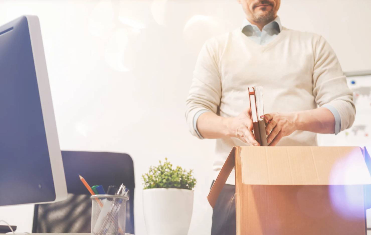 man packing up a desk