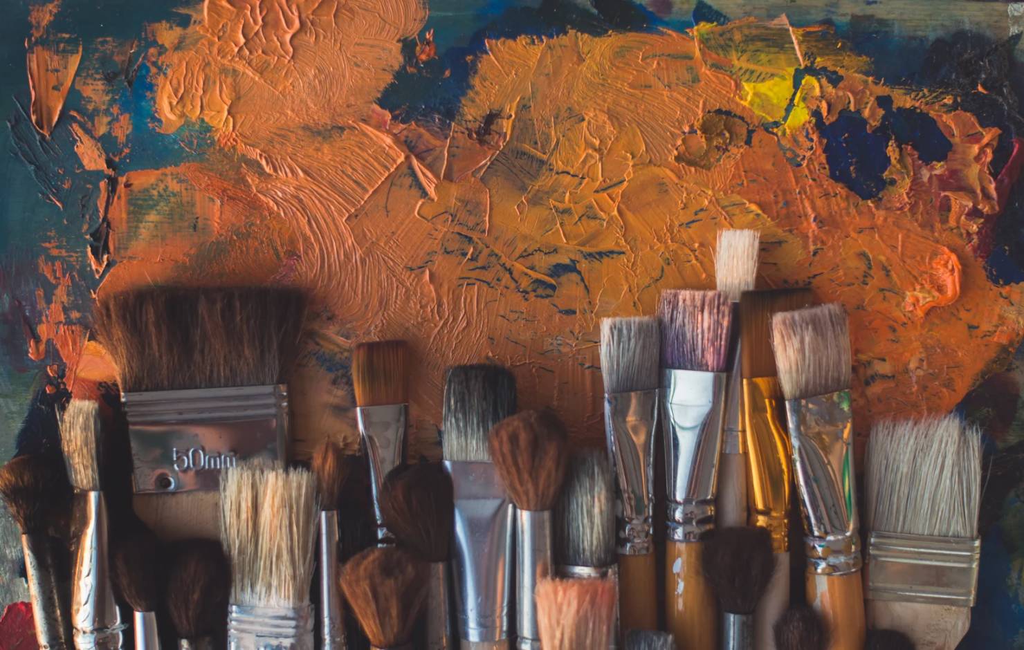 paint brushes and orange paint