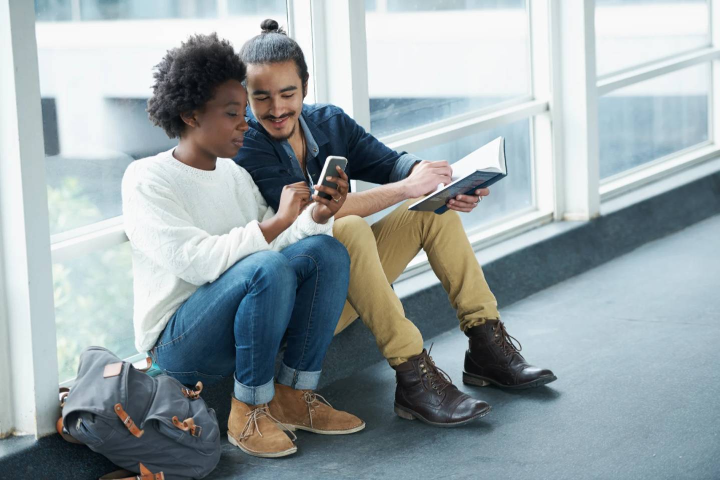 Two people looking at mobile phone