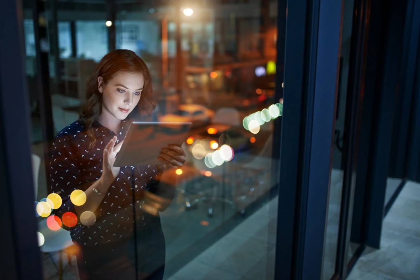 young woman in office with tablet