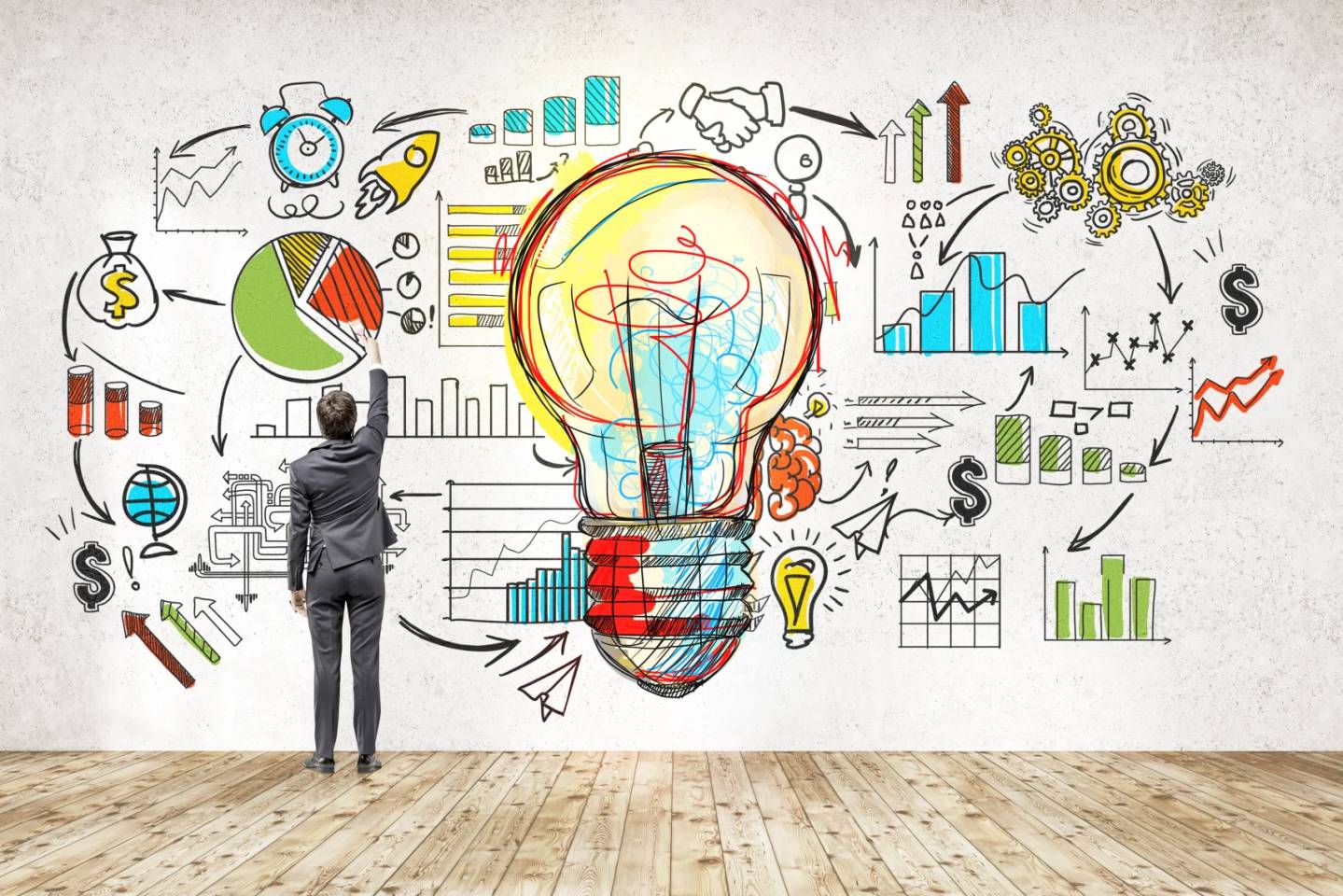 man with drawings on wall implying market research