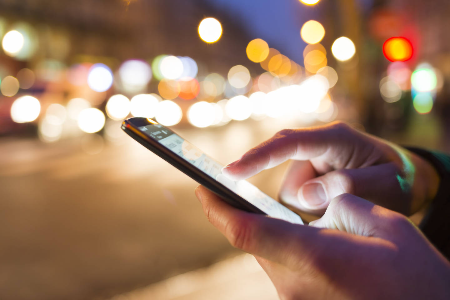 person on cell phone at night
