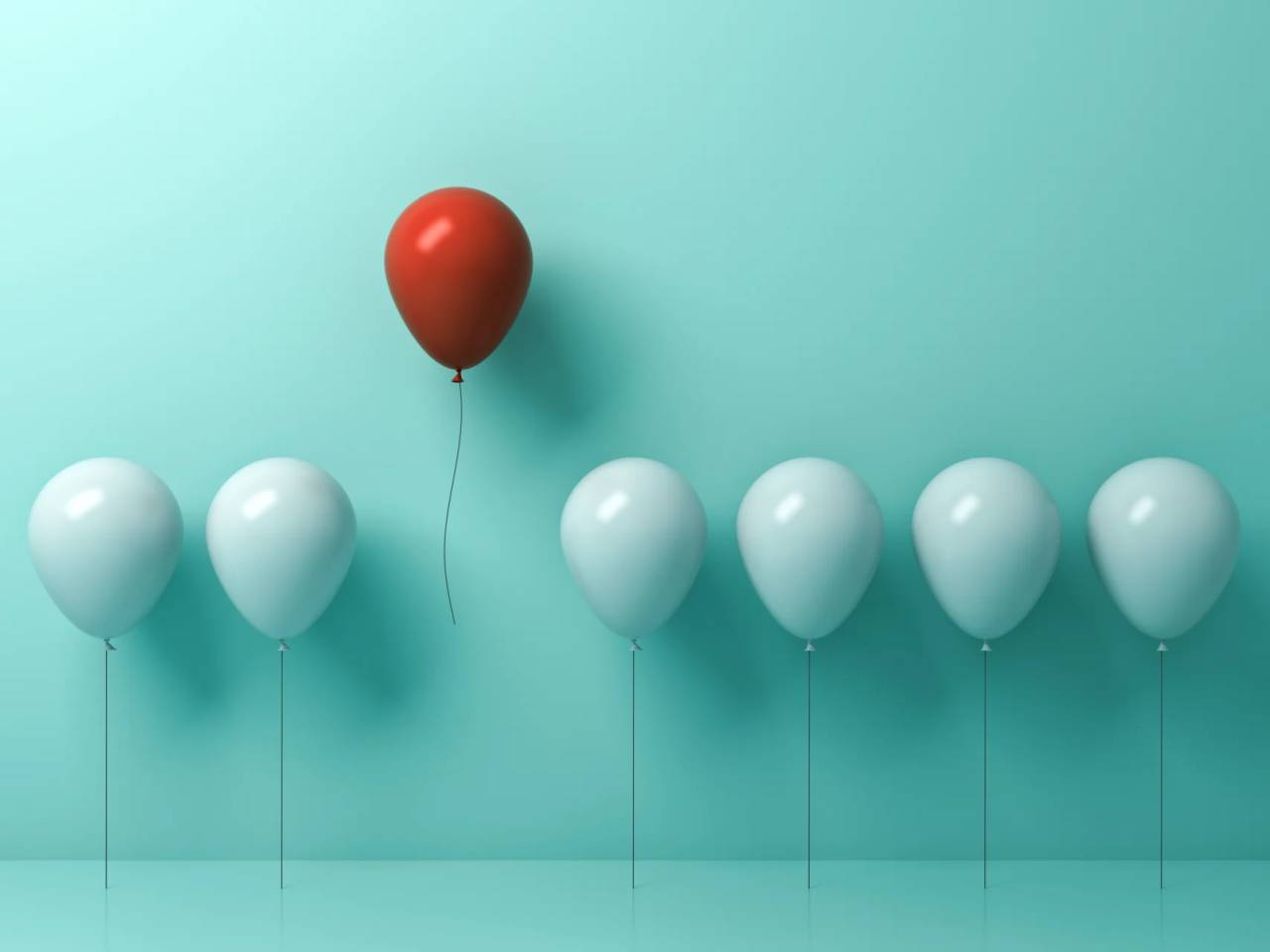 single red balloon standing out among white balloons