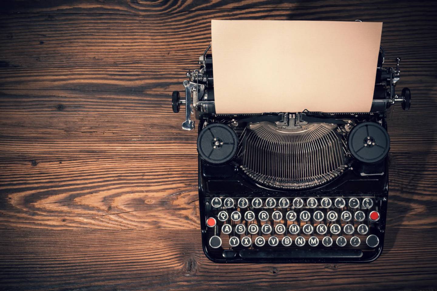 black typewriter on wood desk