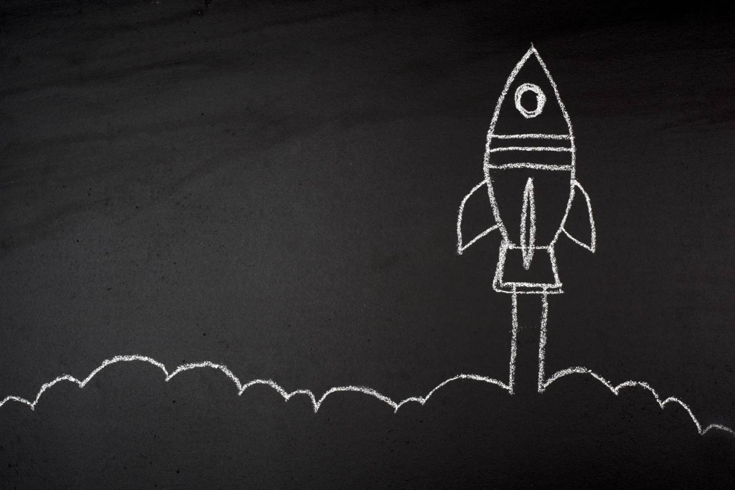 rocket ship drawn on a chalkboard
