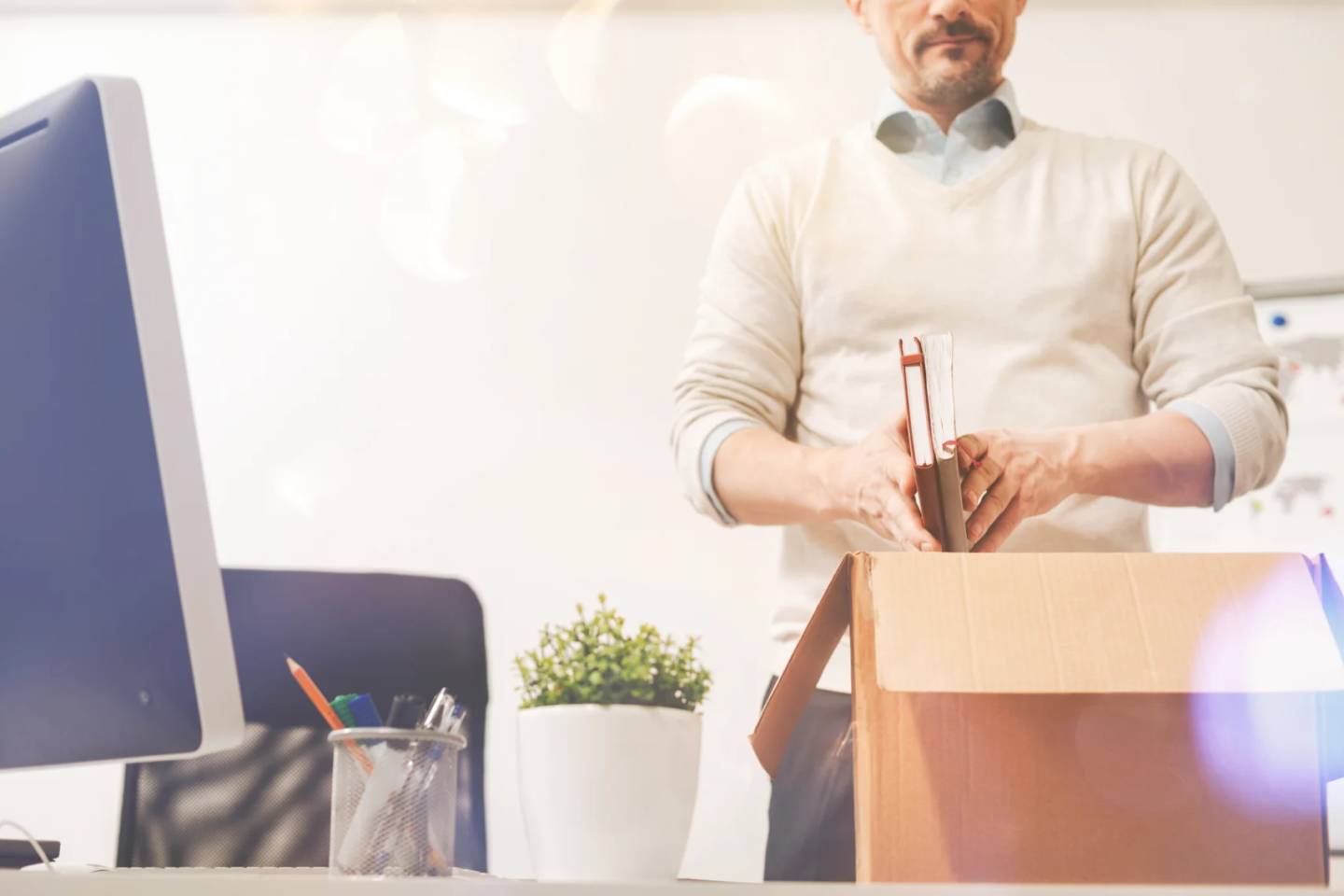 man packing up a desk
