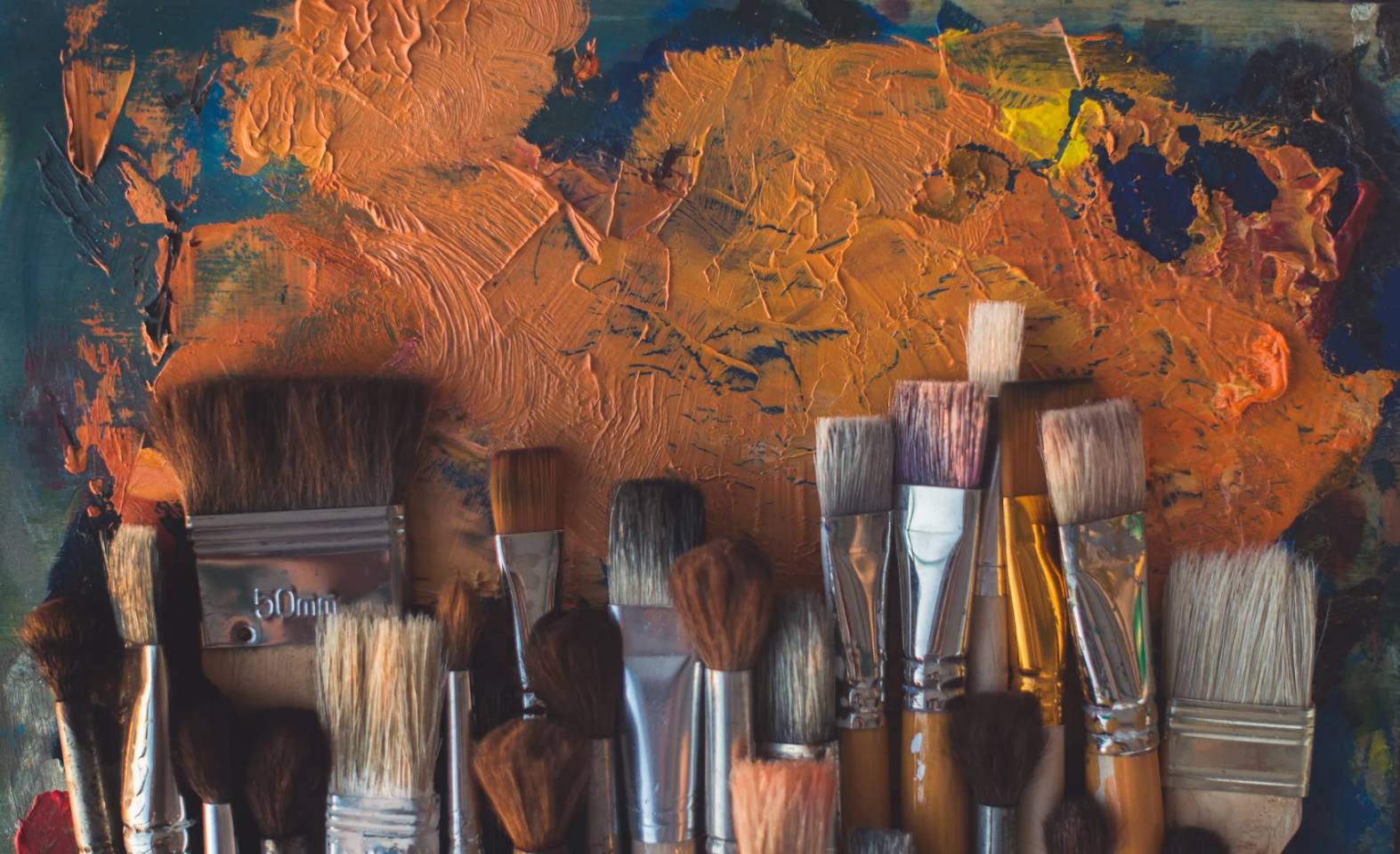 paint brushes and orange paint