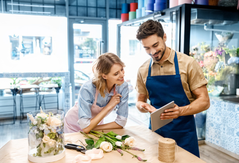Floral shop employees on ipad